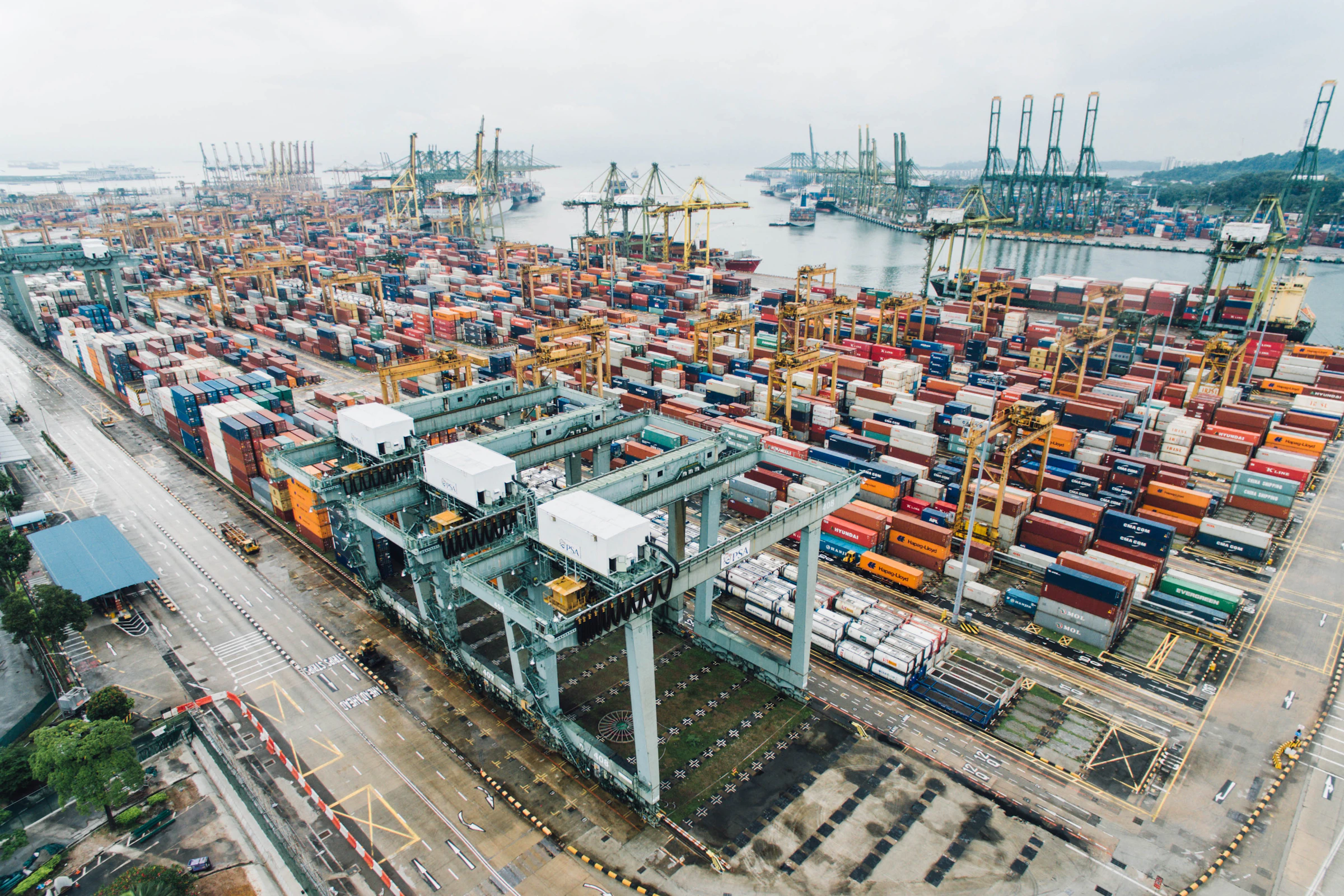 Grey intermodal shipping containers stacked on industrial dock